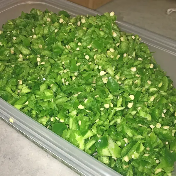 Prepping The Green Peppers In Approved Kitchen